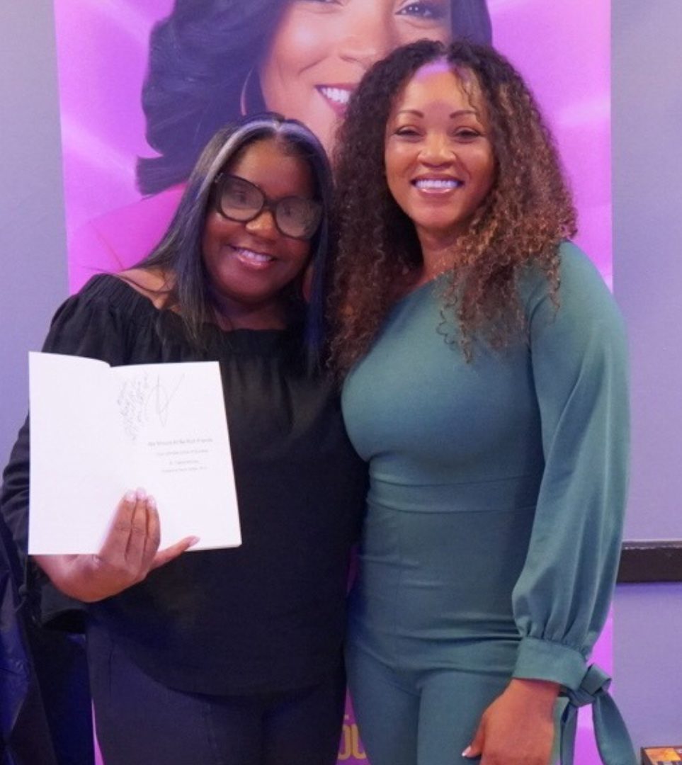 A reader holding her signed copy with Dr. TMac